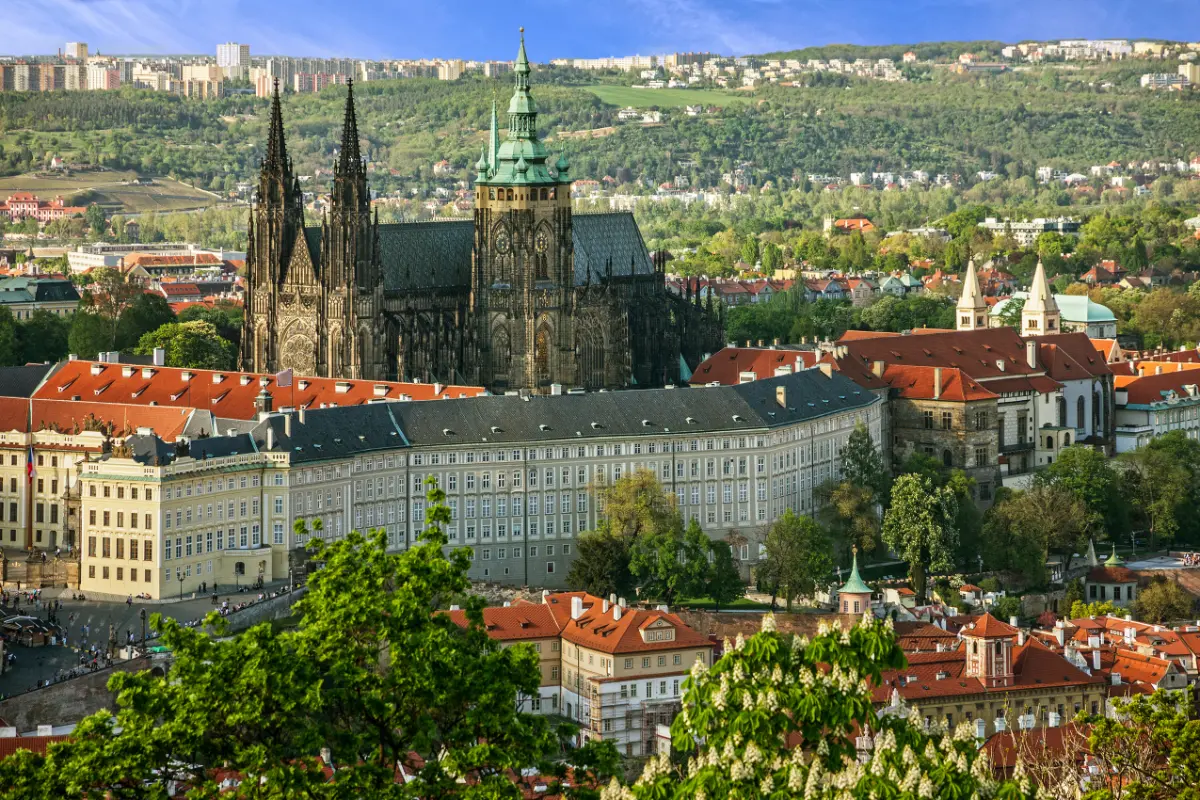 Prague Castle and St. Vitus Cathedral embraced by lush greenery, a panoramic view