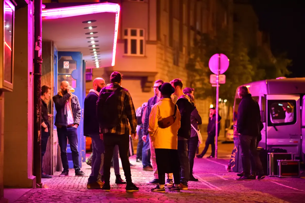 People gather at Palác Akropolis concert hall entrance in Prague